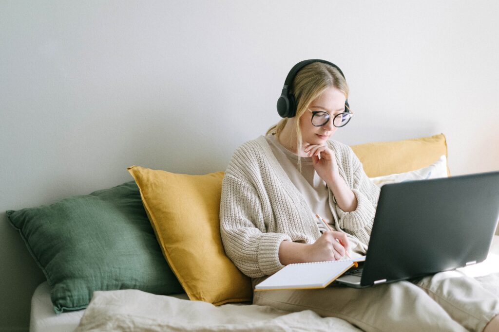 Student sat on bed listening to music